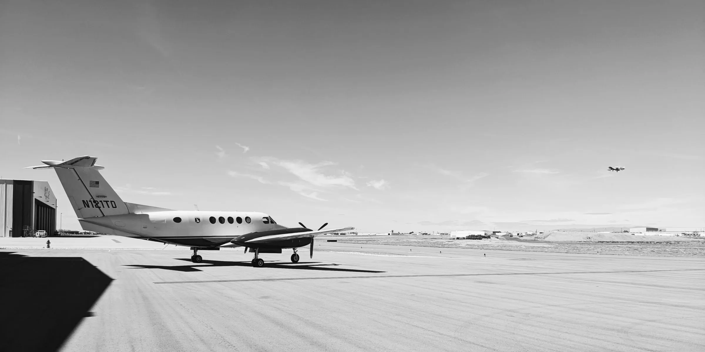 A single turboprop parked on an otherwise empty ramp.