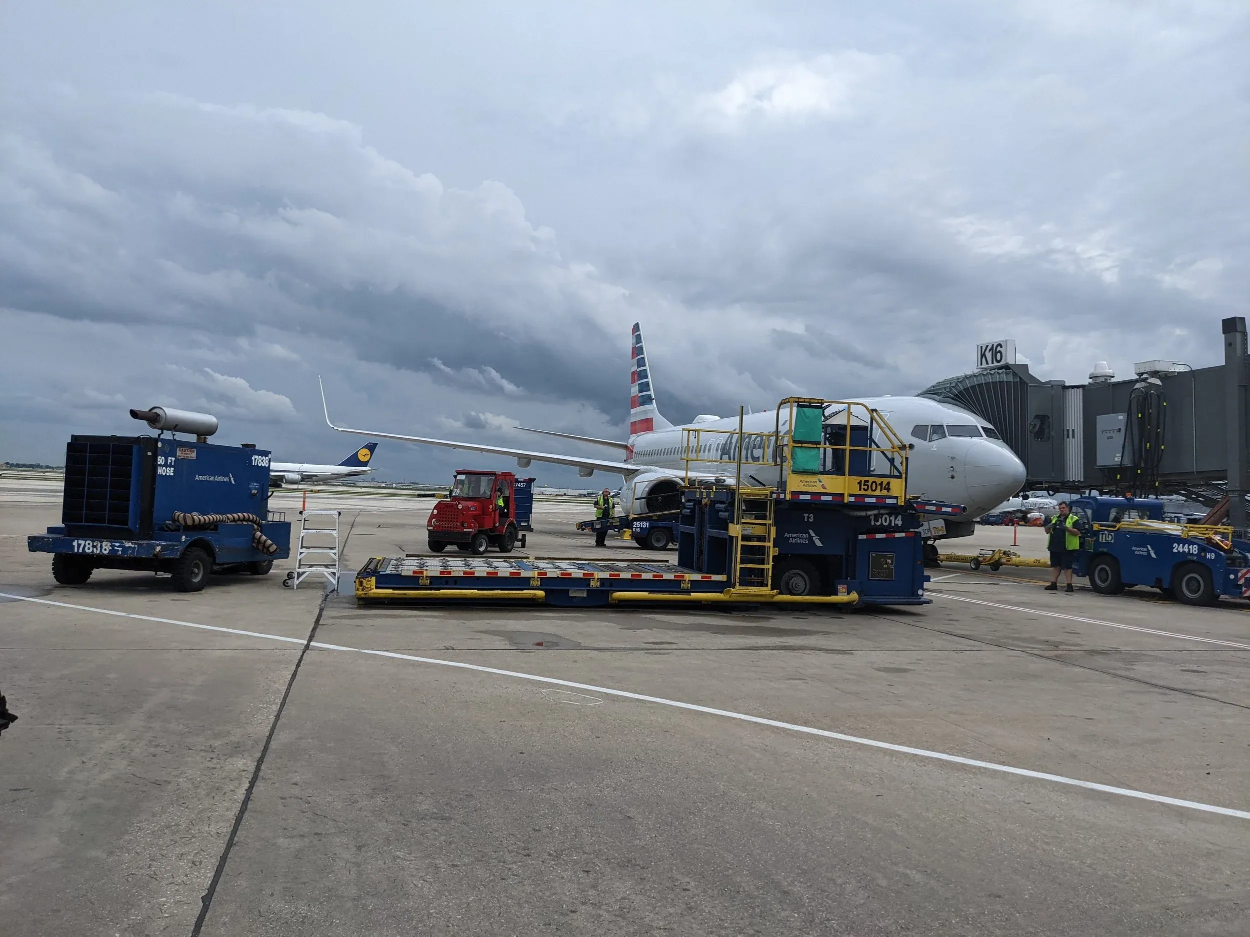 A widebody aircraft at an O’Hare Terminal 3 gate, surrounded by ground support equipment.