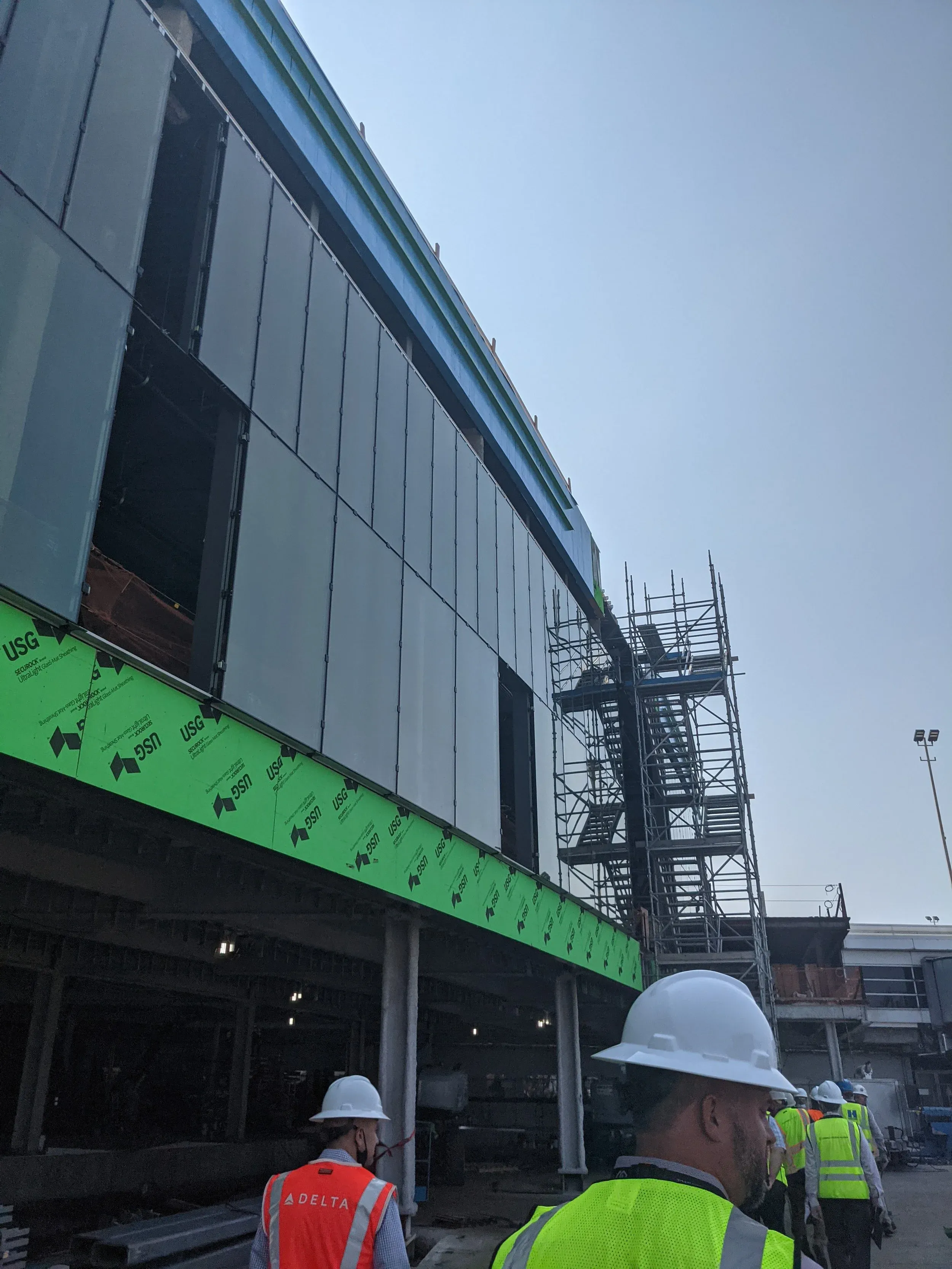Glazing going up at O’Hare Terminal 5, the building’s sheathing still exposed.