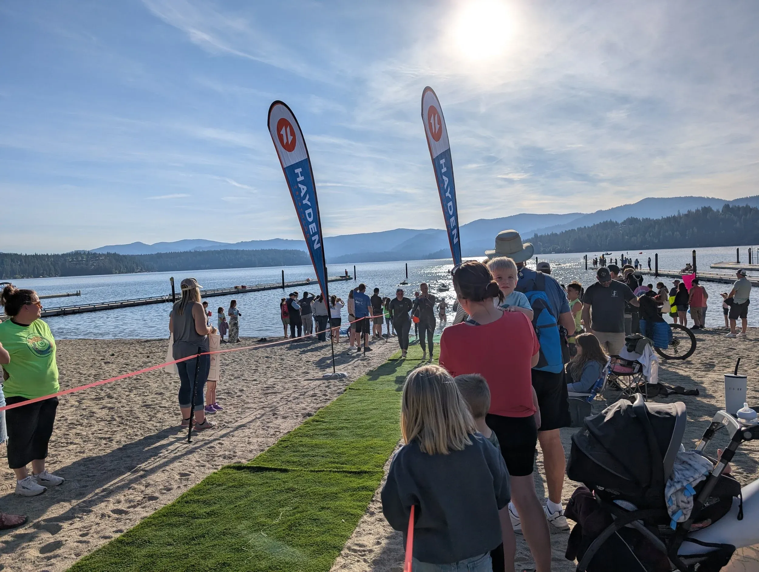 The race start area on the beach, banners up and spectators gathering.